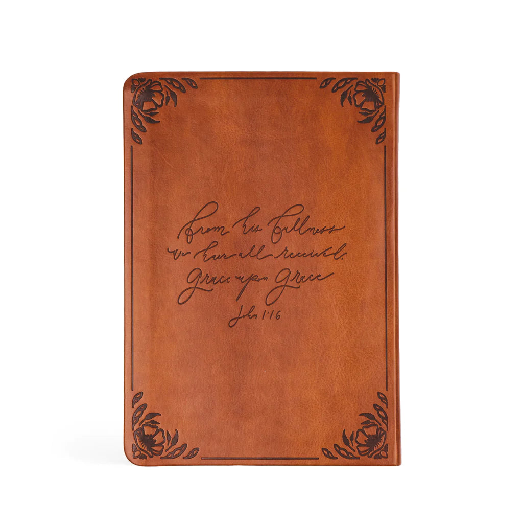 back of brown smooth leather bible with floral etched corners, the middle reads "from his fullness we have all received grace upon grace"