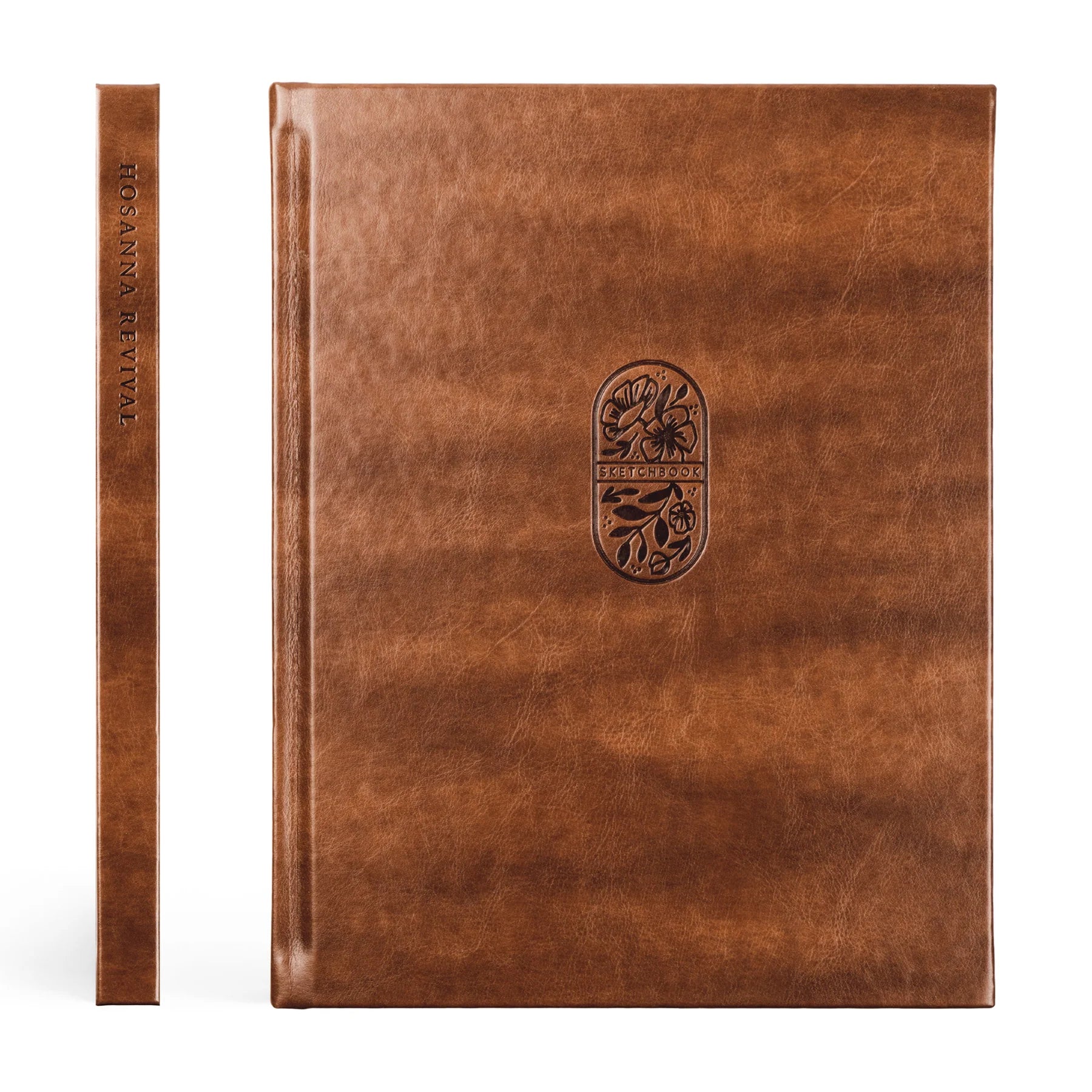 spine and front cover of brown hard cover book with oval floral dsign in the middle of front cover