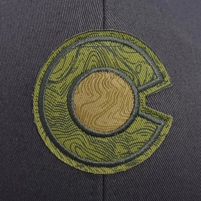 close up of the embrodered colorado c in green and charcoal