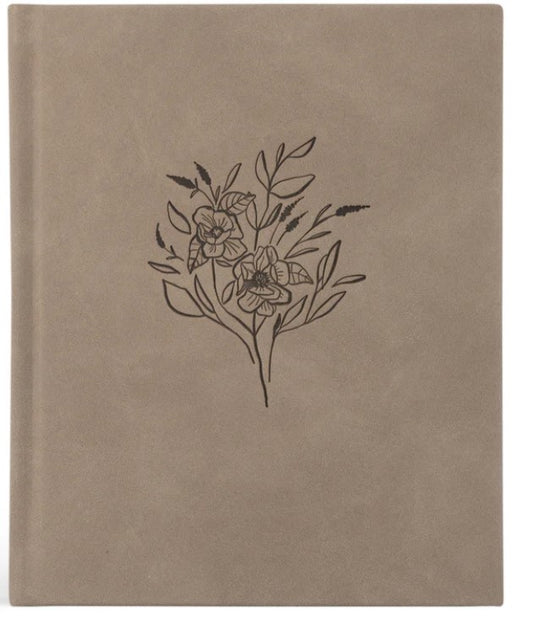 light tan hard cover planner with flowers etched on the front