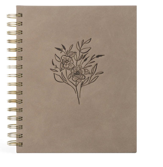 spiral notebook, front is light tan, with flowers etched in the middle